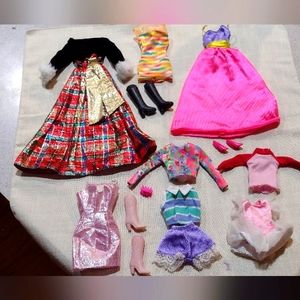 Lot of 9 pieces of Barbie Brand Barbie clothes and additional accessories.